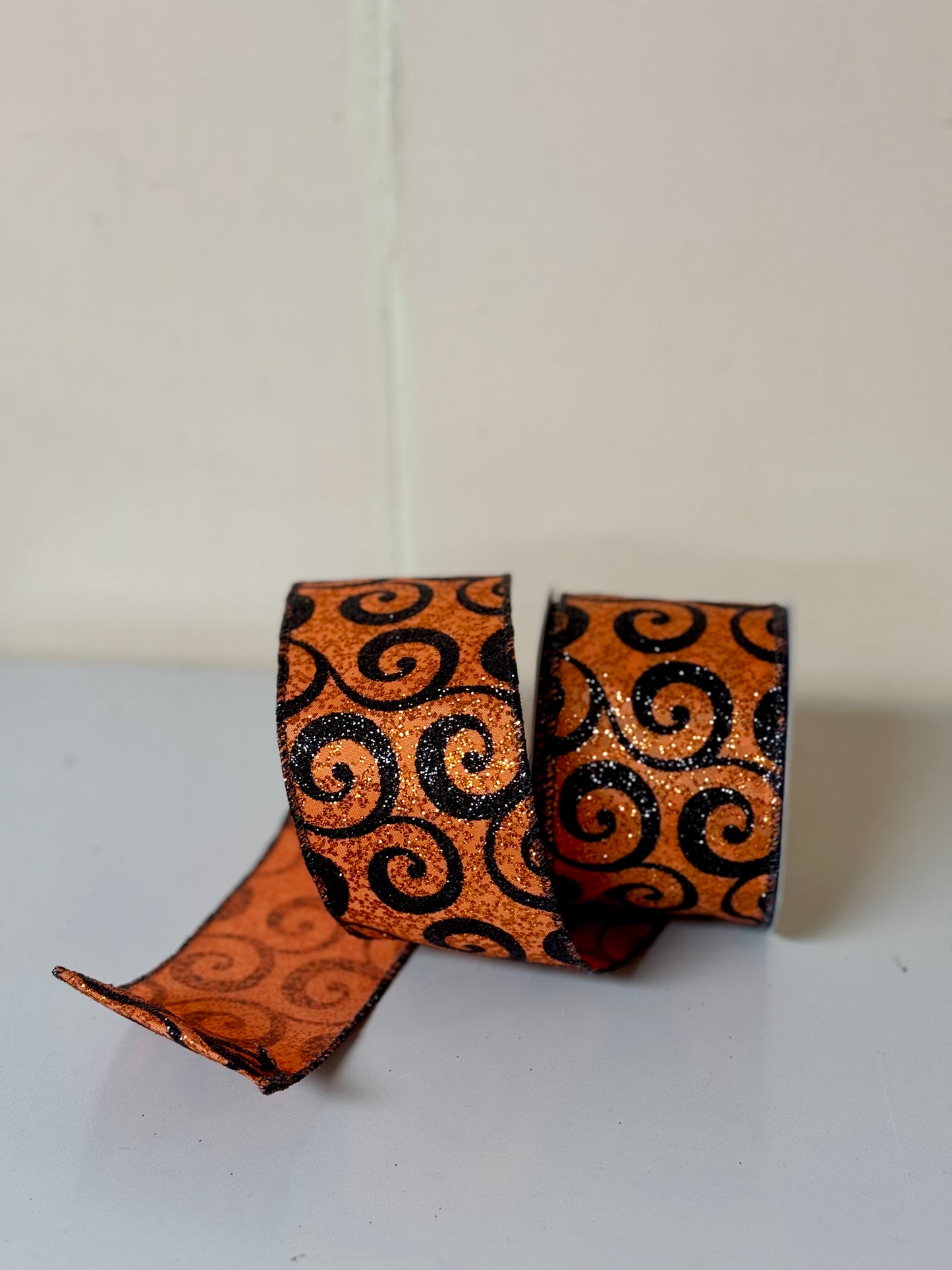 2.5 Inch By 10 Yard Orange With Black Glitter Swirls Ribbon