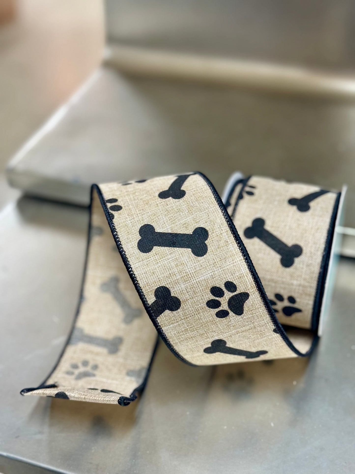 2.5 Inch By 10 Yard Light Beige And Black Paw Print Bones Ribbon