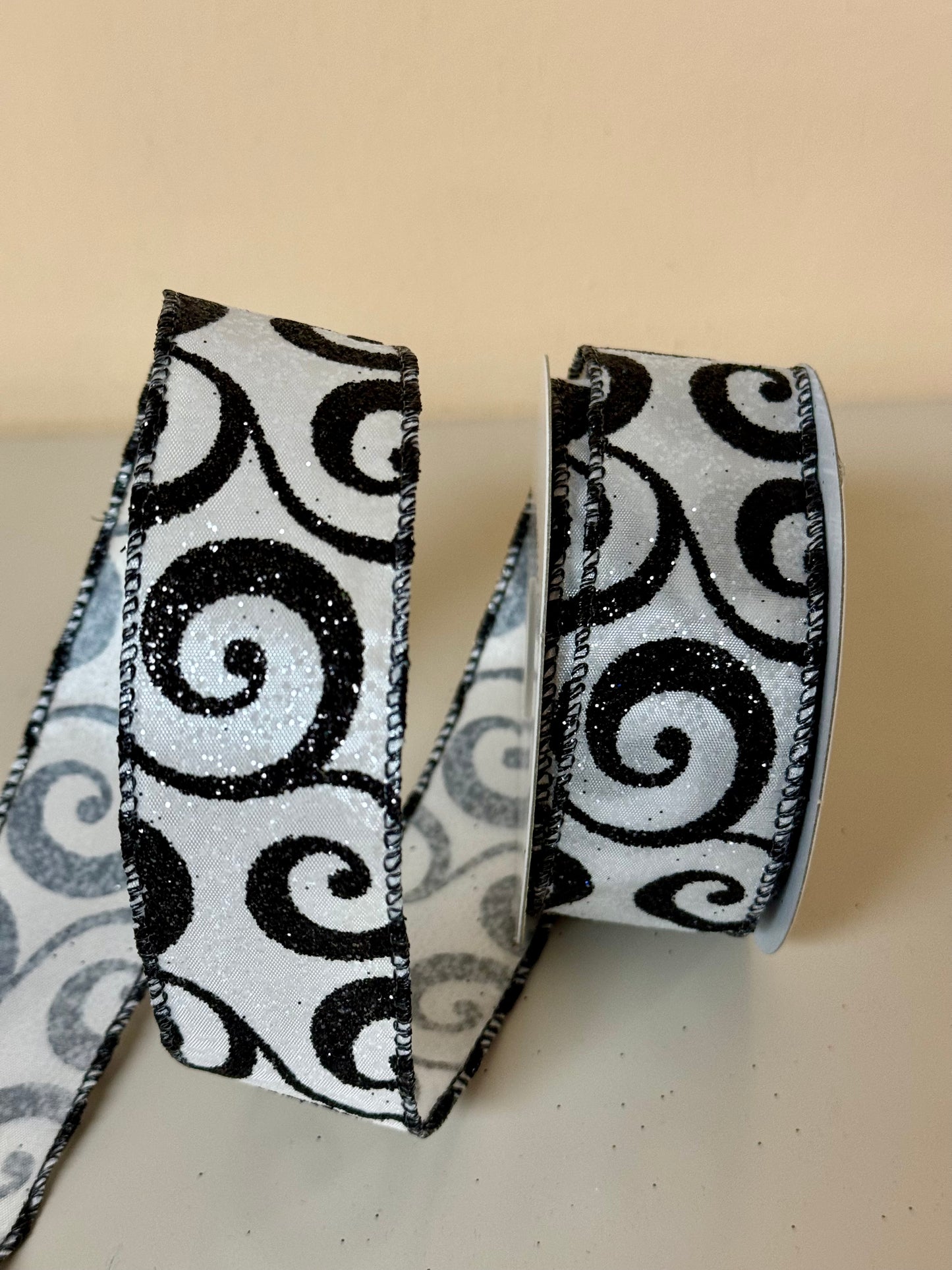 1.5 Inch By 10 Yard White Glitter Ribbon With Black Glitter Swirls