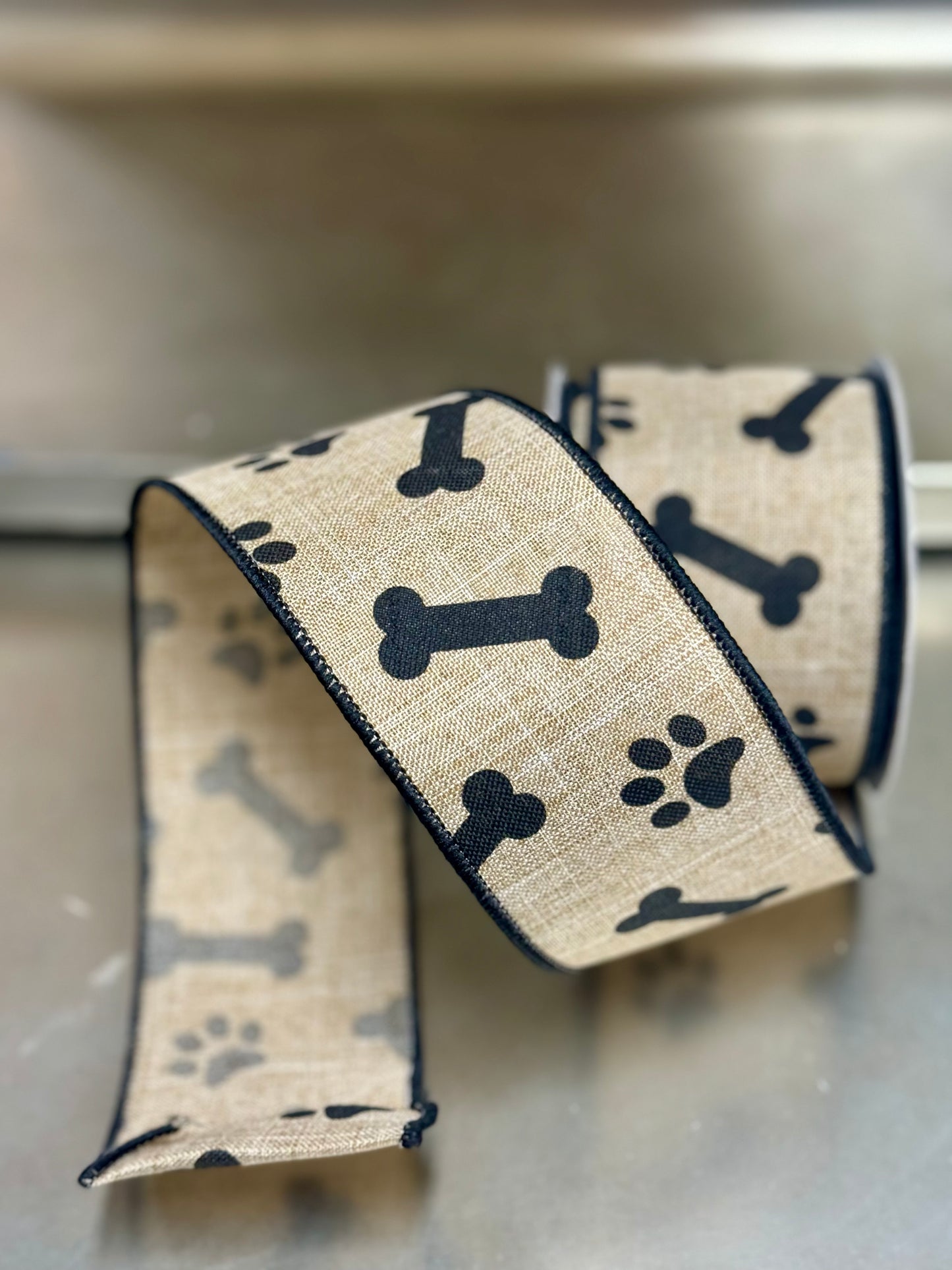 2.5 Inch By 10 Yard Light Beige And Black Paw Print Bones Ribbon