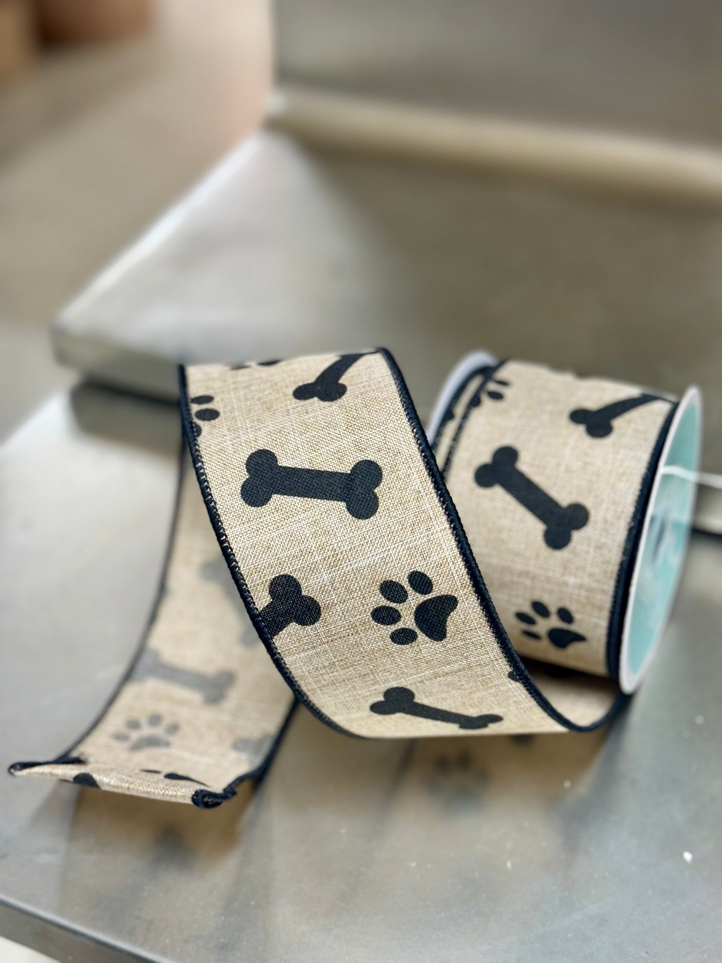 2.5 Inch By 10 Yard Light Beige And Black Paw Print Bones Ribbon