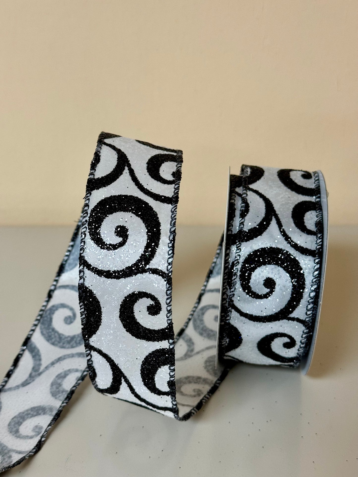 1.5 Inch By 10 Yard White Glitter Ribbon With Black Glitter Swirls