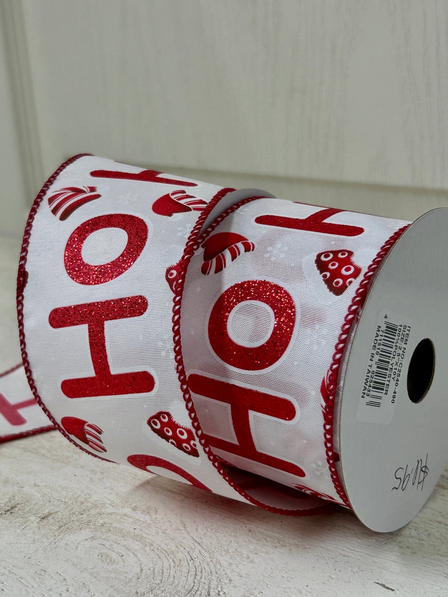 2.5 Inch By 10 Yard Red Glitter Ho Ho Ho With Santa Hats And Snowflakes With White Background And Red Edging Ribbon