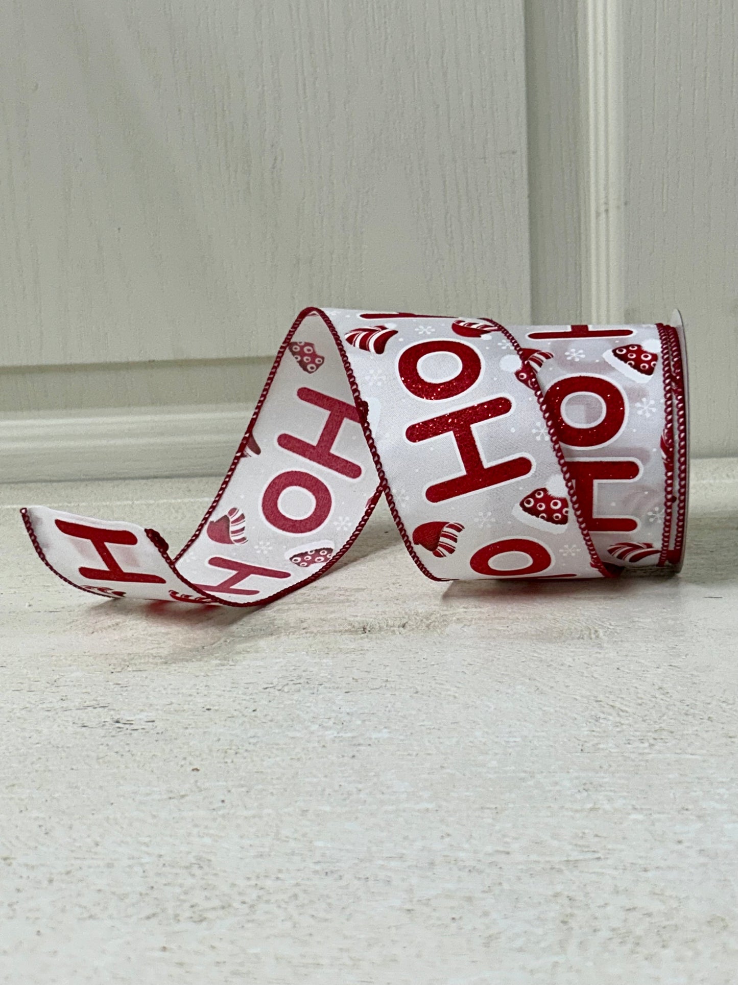 2.5 Inch By 10 Yard Red Glitter Ho Ho Ho With Santa Hats And Snowflakes With White Background And Red Edging Ribbon
