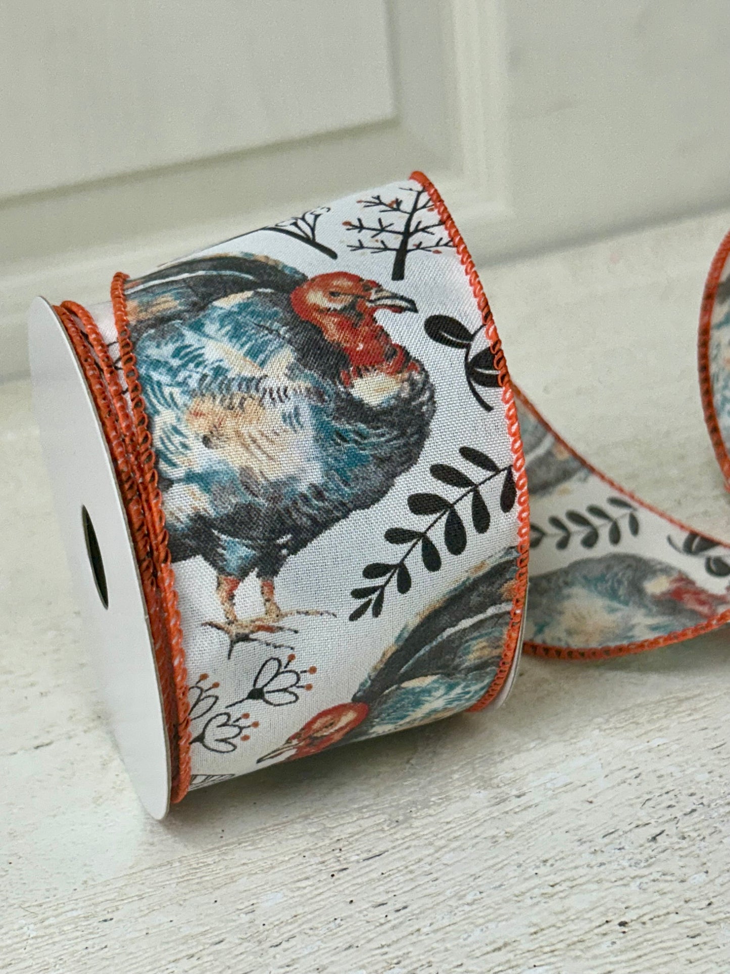 2.5 Inch By 10 Yard Blue And Orange Turkey With Orange Berry Sprays With A White Background And Orange Edging Ribbon