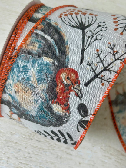 2.5 Inch By 10 Yard Blue And Orange Turkey With Orange Berry Sprays With A White Background And Orange Edging Ribbon