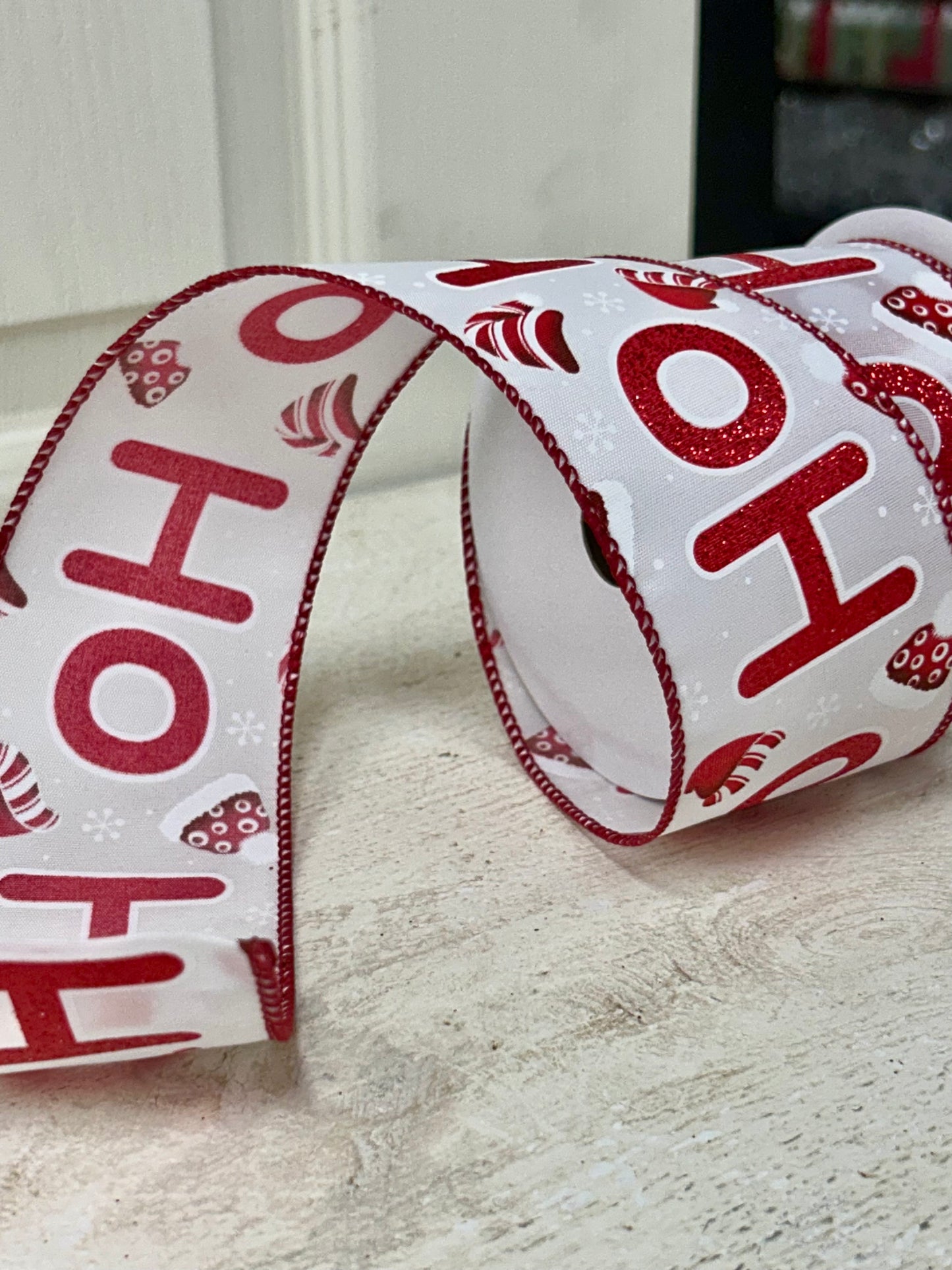 2.5 Inch By 10 Yard Red Glitter Ho Ho Ho With Santa Hats And Snowflakes With White Background And Red Edging Ribbon