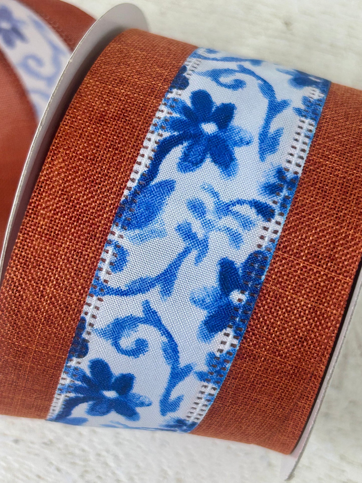 2.5 Inch By 10 Yard Rust Burlap Background With Blue Watercolor Flowers Middle Ribbon