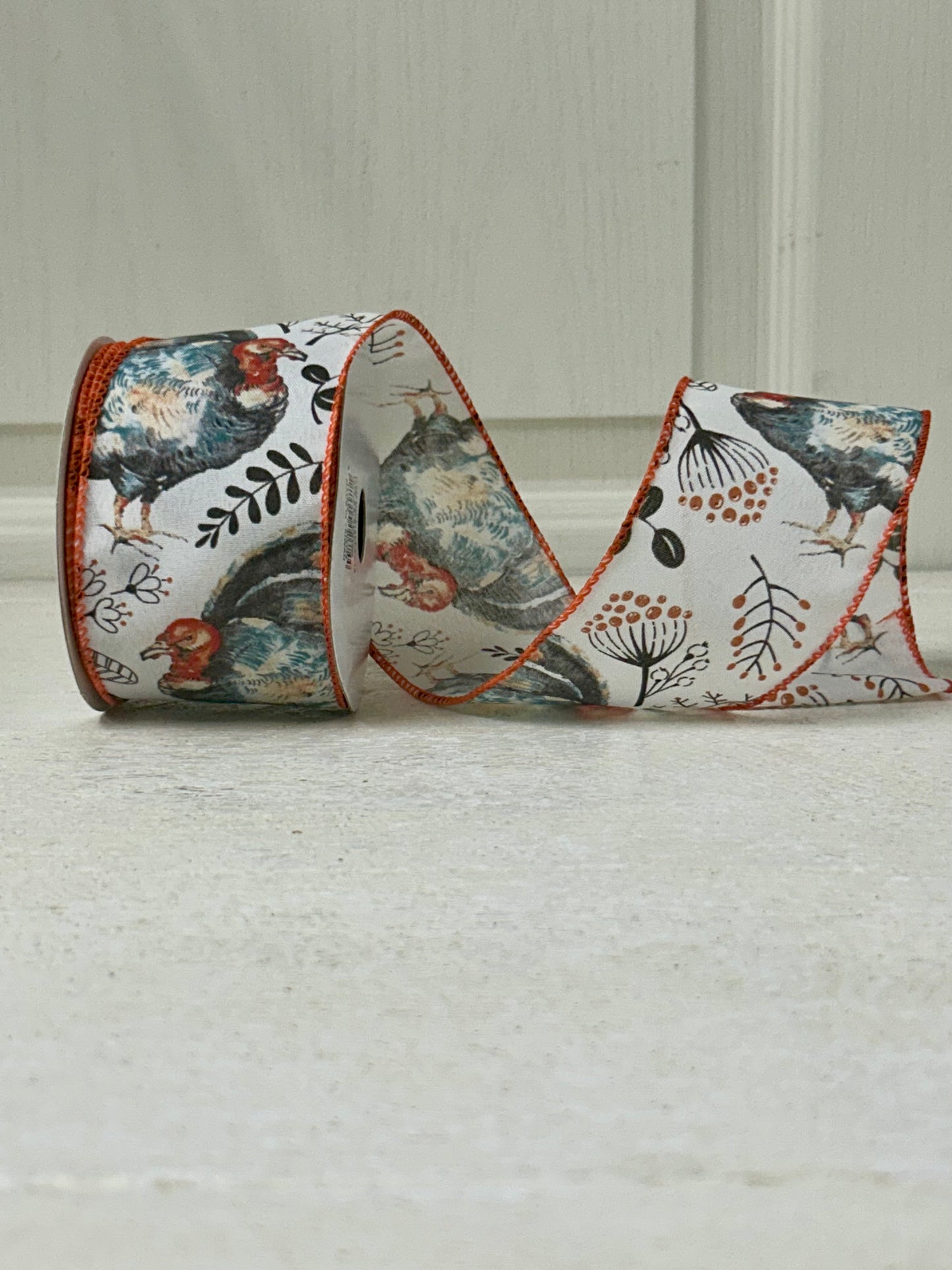 2.5 Inch By 10 Yard Blue And Orange Turkey With Orange Berry Sprays With A White Background And Orange Edging Ribbon